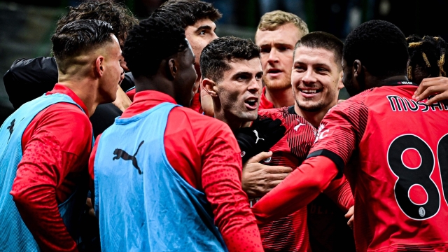 AC Milan's American forward #11 Christian Pulisic (C) celebrates with his teammates after scoring his team's second goal during the Serie A football match between AC Milan and Frosinone at San Siro stadium in Milan, on December 2, 2023. (Photo by Piero CRUCIATTI / AFP)