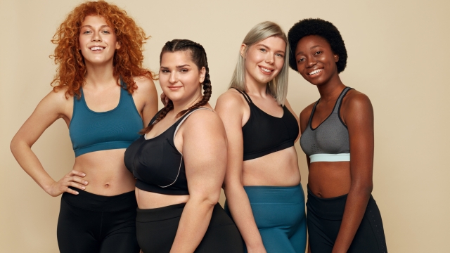 Different Race. Diversity Figure And Size Women Portrait. Smiling Multiethnic Female In Sportswear Posing On Beige Background. Body Positive As Lifestyle.