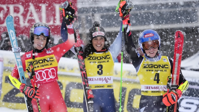 First place finisher Federica Brignone of Italy (3) raises hands together with second place Lara Gut-Behrami of Switzerland and third place Mikaela Shiffrin of the USA (4) at the end of the women's World Cup giant slalom in Mont Tremblant, Quebec,, Sunday, Dec. 3, 2023. (Frank Gunn /The Canadian Press via AP)