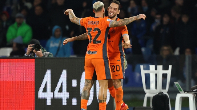 NAPLES, ITALY - DECEMBER 03: Hakan Calhanoglu of FC Internazionale celebrates with teammate Federico Dimarco of FC Internazionale after scoring his side first goal during the Serie A TIM match between SSC Napoli and FC Internazionale at Stadio Diego Armando Maradona on December 03, 2023 in Naples, Italy. (Photo by Francesco Pecoraro/Getty Images)