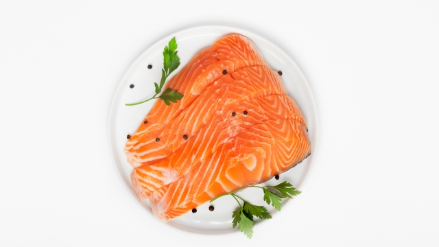 Fresh raw salmon steaks isolated on white background, top view