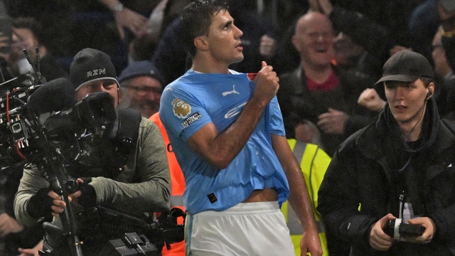 Manchester City's Spanish midfielder #16 Rodri celebrates after his deflected shot makes it 3-4 to City during the English Premier League football match between Chelsea and Manchester City at Stamford Bridge in London on November 12, 2023. (Photo by Glyn KIRK / IKIMAGES / AFP) / RESTRICTED TO EDITORIAL USE. No use with unauthorized audio, video, data, fixture lists, club/league logos or 'live' services. Online in-match use limited to 45 images, no video emulation. No use in betting, games or single club/league/player publications.