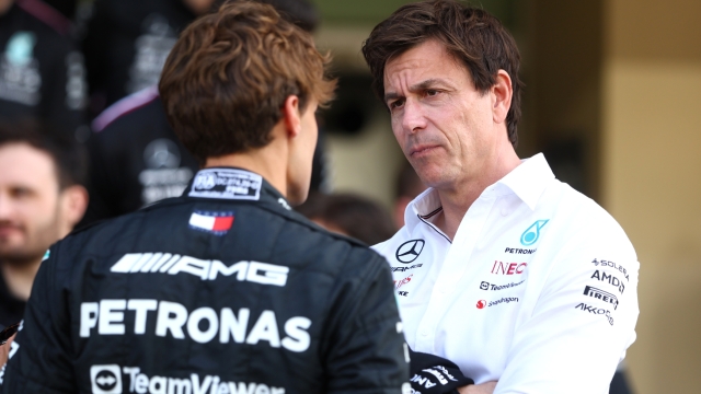 ABU DHABI, UNITED ARAB EMIRATES - NOVEMBER 23: George Russell of Great Britain and Mercedes talks with Mercedes GP Executive Director Toto Wolff at the Mercedes GP Team Photo during previews ahead of the F1 Grand Prix of Abu Dhabi at Yas Marina Circuit on November 23, 2023 in Abu Dhabi, United Arab Emirates. (Photo by Clive Rose/Getty Images)