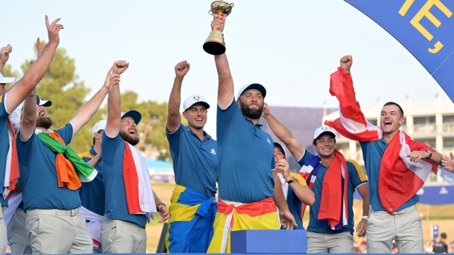 Europe's Spanish Jon Rahm (C) flanked by his teammates celebrate with the trophy after winning the 2023 Ryder Cup golf tournament at Marco Simone Golf Club in Guidonia, near Rome, Italy, 01 October 2023. The 44th Ryder Cup matches between the US and Europe will be held in Italy from 29 September to 01 October 2023.   ANSA/ETTORE FERRARI