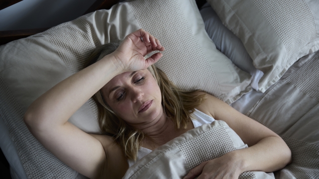 Menopausal Mature Woman Suffering With Insomnia In Bed At Home