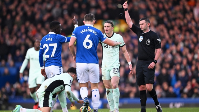 LIVERPOOL, ENGLAND - DECEMBER 10: Referee, Michael Oliver shows a yellow card to Idrissa Gana Gueye of Everton during the Premier League match between Everton FC and Chelsea FC at Goodison Park on December 10, 2023 in Liverpool, England. (Photo by Michael Regan/Getty Images)