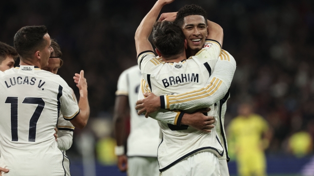Real Madrid's Spanish forward #21 Brahim Diaz hugs Real Madrid's English midfielder #5 Jude Bellingham after scoring his team's third goal during the Spanish league football match between Real Madrid CF and Villarreal CF at the Santiago Bernabeu stadium in Madrid on December 17, 2023. (Photo by Thomas COEX / AFP)