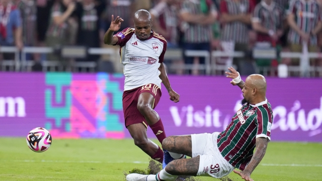 Fluminense's Felipe Melo tries to tackle Al Ahly's Percy Tau, left, during the Soccer Club World Cup semifinal soccer match between Fluminense FC and Al Ahly FC at King Abdullah Sports City Stadium in Jeddah, Saudi Arabia, Monday, Dec. 18, 2023. (AP Photo/Manu Fernandez)