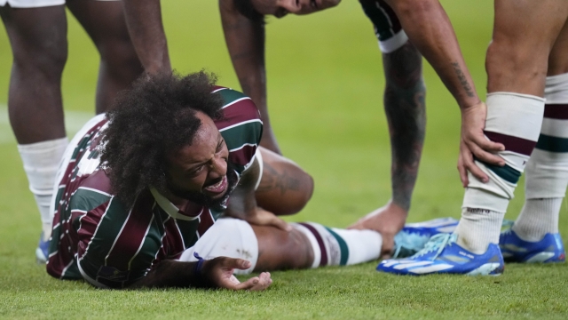 Fluminense's Marcelo grimaces on the ground after getting injured during the Soccer Club World Cup semifinal soccer match between Fluminense FC and Al Ahly FC at King Abdullah Sports City Stadium in Jeddah, Saudi Arabia, Monday, Dec. 18, 2023. (AP Photo/Manu Fernandez)