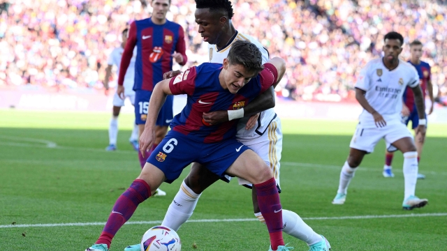 Barcelona's Spanish midfielder #06 Gavi fights for the ball with Real Madrid's Brazilian forward #07 Vinicius Junior during the Spanish league football match between FC Barcelona and Real Madrid CF at the Estadi Olimpic Lluis Companys in Barcelona on October 28, 2023. (Photo by Josep LAGO / AFP)