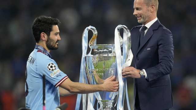 FILE - UEFA president Aleksander Ceferin hands the trophy to Manchester City's team captain Ilkay Gundogan after the the Champions League final soccer match between Manchester City and Inter Milan in Istanbul, Turkey, Sunday, June 11, 2023. The European Union?s top court has ruled UEFA and FIFA acted contrary to EU competition law by blocking plans for the breakaway Super League. The case was heard last year at the Court of Justice after Super League failed at launch in April 2021. UEFA President Aleksander Ceferin called the club leaders ?snakes? and ?liars.? (AP Photo/Francisco Seco, File)