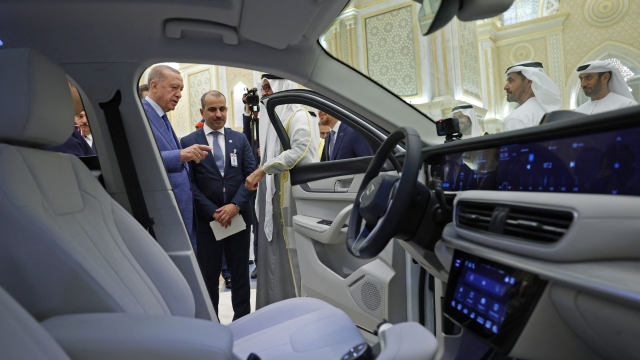 This handout image provided by the Turkish Presidency Press Office shows Turkey's President Recep Tayyip Erdogan gifting the first domestically produced electric car 'Togg' to UAE's President Mohamed bin Zayed al-Nahyan in Abu Dhabi on July 19, 2023. (Photo by HANDOUT / TURKISH PRESIDENTIAL PRESS SERVICE / AFP) / === RESTRICTED TO EDITORIAL USE - MANDATORY CREDIT "AFP PHOTO / TURKISH PRESIDENCY- NO MARKETING NO ADVERTISING CAMPAIGNS - DISTRIBUTED AS A SERVICE TO CLIENTS ===