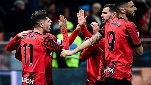 AC Milan's American forward #11 (L) Christian Pulisic celebrates with teammates after scoring his team first goal during the Italian Serie A football match between AC Milan and Sassuolo at the San Siro stadium, in Milan on December 30, 2023. (Photo by Piero CRUCIATTI / AFP)