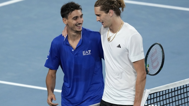 Italy's Lorenzo Sonego, left, and Germany's Alexander Zverev meet at the net following Zverev's win in their match during the United Cup tennis tournament in Sydney, Saturday, Dec. 30, 2023. (AP Photo/Rick Rycroft)