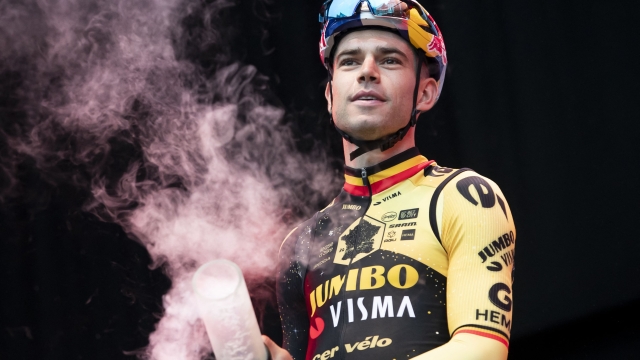 Jumbo-Visma's Belgian rider Wout Van Aert light a flare at the start of the 'Natourcriterium Herentals' cycling race in Herentals on July 27, 2023. (Photo by KRISTOF VAN ACCOM / Belga / AFP) / Belgium OUT