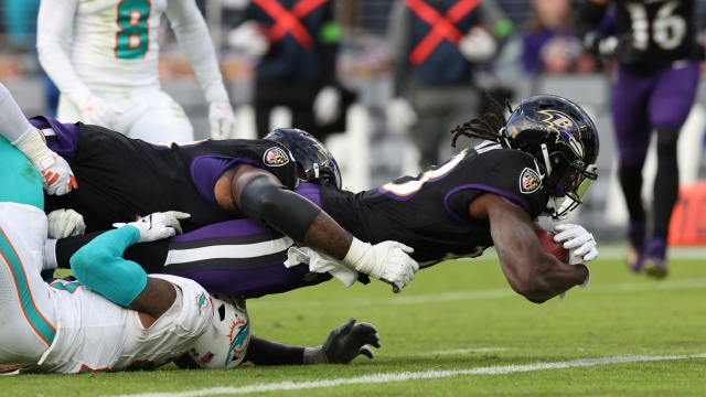 BALTIMORE, MARYLAND - DECEMBER 31: Melvin Gordon III #33 of the Baltimore Ravens carries the ball for a touchdown against the Miami Dolphins during the fourth quarter of the game at M&T Bank Stadium on December 31, 2023 in Baltimore, Maryland.   Todd Olszewski/Getty Images/AFP (Photo by Todd Olszewski / GETTY IMAGES NORTH AMERICA / Getty Images via AFP)