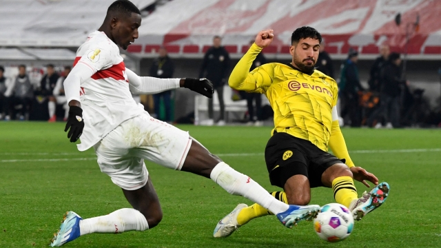 TOPSHOT - Stuttgart's Guinean forward #09 Serhou Guirassy (L) and Dortmund's German midfielder #23 Emre Can vie for the ball during the German Cup (DFB Pokal) round of 16 football match between VfB Stuttgart and Borussia Dortmund in Stuttgart, southwestern Germany on December 6, 2023. (Photo by Thomas KIENZLE / AFP) / DFB REGULATIONS PROHIBIT ANY USE OF PHOTOGRAPHS AS IMAGE SEQUENCES AND QUASI-VIDEO.