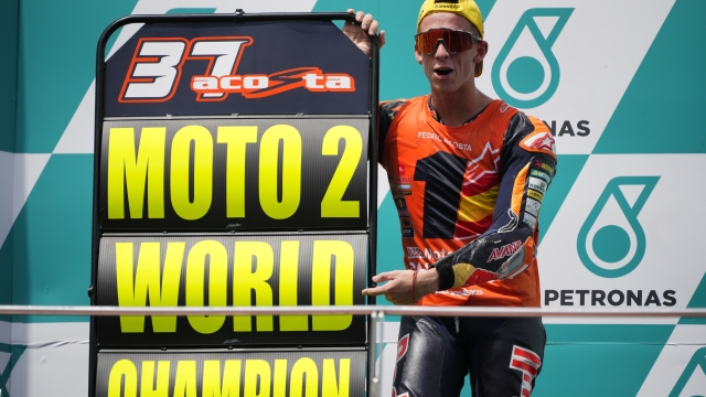 Spanish rider Pedro Acosta celebrates his 2023 Moto2 World Champion after the Moto2 class race of the MotoGP Malaysian Grand Prix at the Sepang, Malaysia Sunday, Nov. 12, 2023. (AP Photo/Vincent Thian)