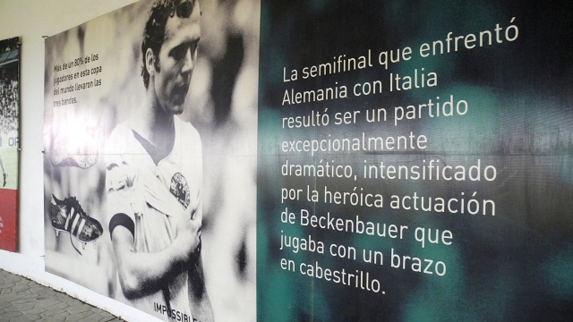 A photo in the catacombs of the Estadio Azteca commemorates Franz Beckenbauer, who played for West Germany in the 'Game of the Century' against Italy during the 1970 FIFA World Cup with a bandaged arm, in Mexico City, Mexico, 4 May 2016. The Estadio Azteca opened in 1966. Photo: Denis Duettmann/dpa (Photo by Denis Düttmann / DPA / dpa Picture-Alliance via AFP)