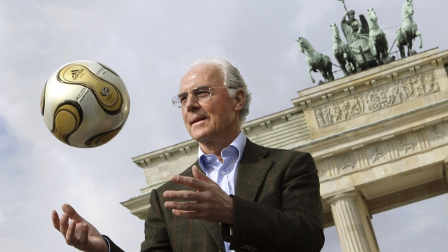 The President of the 2006 World Cup Organizing Committee, Franz Beckenbauer, presents the golden soccer ball for the 2006 World Cup final in front of the Brandenburg Gate on April 18, 2006. Germany's World Cup-winning coach Franz Beckenbauer has died. He was 78. Beckenbauer was one of German soccer's central figures. He captained West Germany to the World Cup title in 1974. He also coached the national side for its 1990 World Cup win against Argentina. (Peer Grimm/dpa/dpa via AP)