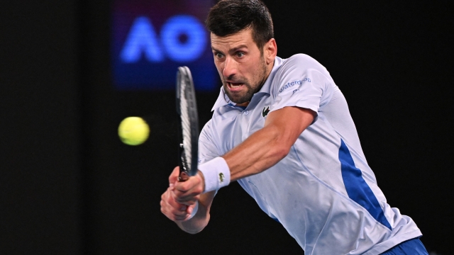 Serbia's Novak Djokovic hits a return against Croatia's Dino Prizmic during their men's singles match on day one of the Australian Open tennis tournament in Melbourne on January 14, 2024. (Photo by WILLIAM WEST / AFP) / -- IMAGE RESTRICTED TO EDITORIAL USE - STRICTLY NO COMMERCIAL USE --