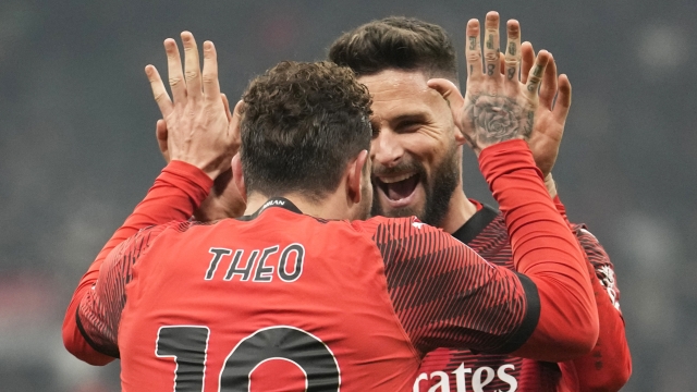 AC Milan's Theo Hernandez, left, celebrates with Olivier Giroud after scoring his side's third goal during the Serie A soccer match between AC Milan and Roma at the San Siro stadium in Milan, Italy, Sunday, Jan. 14, 2024. (AP Photo/Luca Bruno)