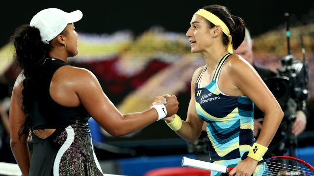 MELBOURNE, AUSTRALIA - JANUARY 15: Caroline Garcia of France embraces Naomi Osaka of Japan after winning in their round one singles match during the 2024 Australian Open at Melbourne Park on January 15, 2024 in Melbourne, Australia. (Photo by Cameron Spencer/Getty Images)