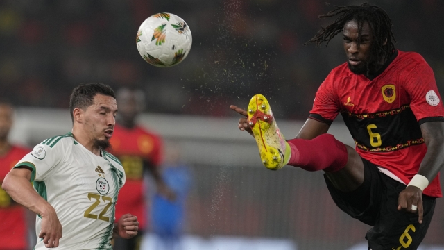 Angola's Kialonda Gaspar, right, challenges for the ball with Algeria's Ismael Bennacer during the African Cup of Nations Group D soccer match between Algeria and Angola in Bouake, Ivory Coast, Monday, Jan. 15, 2024. (AP Photo/Themba Hadebe)