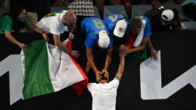 Italy's Lorenzo Sonego celebrates victory against Britain's Daniel Evans with supporters after the men's singles match on day three of the Australian Open tennis tournament in Melbourne on January 16, 2024. (Photo by Anthony WALLACE / AFP) / -- IMAGE RESTRICTED TO EDITORIAL USE - STRICTLY NO COMMERCIAL USE --