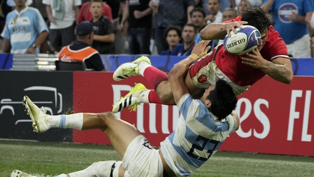 Argentina's Matias Moroni, left, tackles Wales' Louis Rees-Zammit during the Rugby World Cup quarterfinal match between Wales and Argentina at the Stade Vélodrome, in Marseille, France, Saturday, Oct. 14, 2023. (AP Photo/Laurent Cipriani)