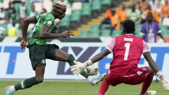 Nigeria's Victor Osimhen, left, kicks the ball against Equatorial Guinea's goalkeeper Jesus Owono during the African Cup of Nations Group A soccer match between Nigeria and Equatorial Guinea's in Abidjan, Ivory Coast, Sunday, Jan. 14, 2024. (AP Photo/Sunday Alamba)