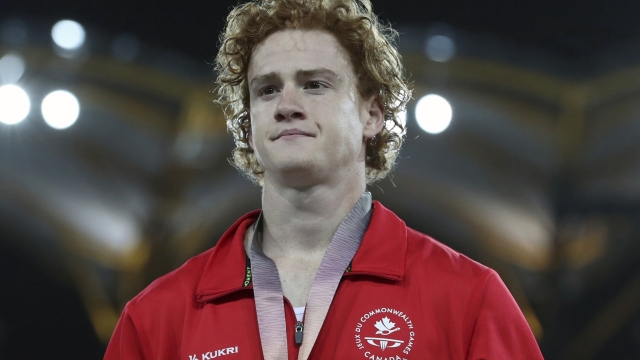 FILE - Men's pole vault silver medalist Canada's Shawnacy Barber is shown on the podium at Carrara Stadium during the 2018 Commonwealth Games on the Gold Coast, Australia, Thursday, April 12, 2018. Barber has died from medical complications. He was 29. Barber died Wednesday, Jan. 17, 2024, at home in Kingwood, Texas, his agent, Paul Doyle, confirmed to The Associated Press. (AP Photo/Mark Schiefelbein, File)