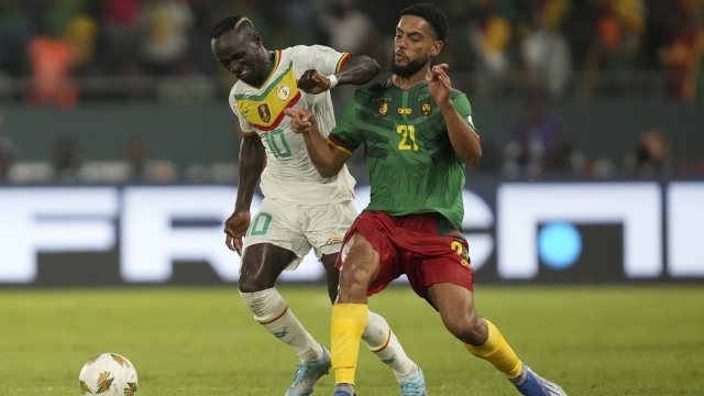 Senegal's Sadio Mane, left, is challenged by Cameroon's Jean Charles Castelletto during the African Cup of Nations Group C soccer match between Senegal and Cameroon, at the Charles Konan Banny stadium in Yamoussoukro, Ivory Coast, Friday, Jan. 19, 2024. (AP Photo/Sunday Alamba)