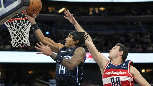 Orlando Magic guard Gary Harris (14) gets past Washington Wizards forward Danilo Gallinari (88) for a shot during the first half of an NBA basketball game Friday, Dec. 1, 2023, in Orlando, Fla. (AP Photo/John Raoux)