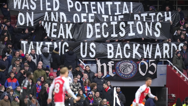 Crystal Palace fans hold a banner on the stands during the English Premier League soccer match between Arsenal and Crystal Palace at Emirates Stadium in London, Saturday, Jan. 20, 2024. (AP Photo/Kirsty Wigglesworth)