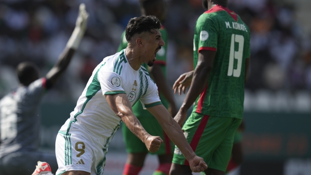 Algeria's Baghdad Bounedjah celebrates after scoring his side's opening goal during the African Cup of Nations Group D soccer match between Algeria and Burkina Faso at the Peace of Bouake stadium in Bouake, Ivory Coast, Saturday, Jan. 20, 2024. (AP Photo/Themba Hadebe)