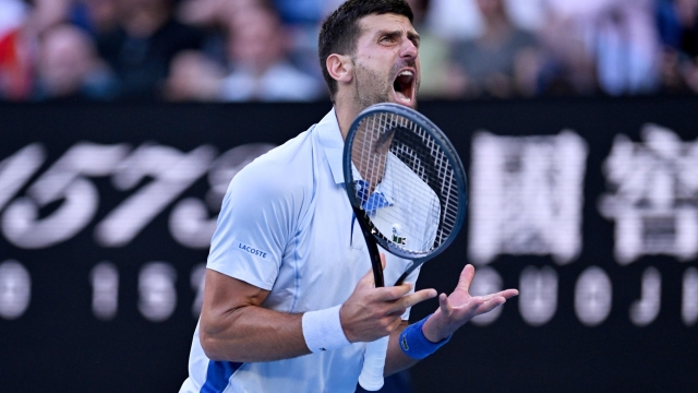epa11097922 Novak Djokovic of Serbia yells during his quarterfinal match against Taylor Fritz of USA at the 2024 Australian Open in Melbourne, Australia, 23 January 2024.  EPA/LUKAS COCH AUSTRALIA AND NEW ZEALAND OUT