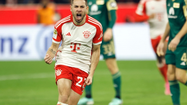 Bayern Munich's Portuguese defender #22 Raphael Guerreiro celebrates scoring the opening goal during the German first division Bundesliga football match between FC Bayern Munich and Union Berlin in Munich on January 24, 2024. (Photo by MICHAELA STACHE / AFP) / DFL REGULATIONS PROHIBIT ANY USE OF PHOTOGRAPHS AS IMAGE SEQUENCES AND/OR QUASI-VIDEO