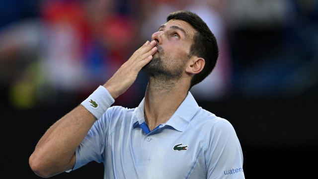 epa11097969 Novak Djokovic of Serbia celebrates winning his quarterfinal match against Taylor Fritz of USA at the 2024 Australian Open in Melbourne, Australia, 23 January 2024.  EPA/LUKAS COCH AUSTRALIA AND NEW ZEALAND OUT