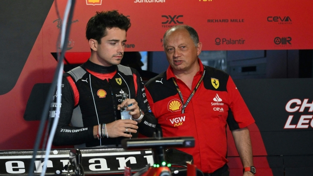 Ferrari's Monegasque driver Charles Leclerc (L) speaks with Team principal Frederic Vasseur before the second practice session for the 2023 Miami Formula One Grand Prix at the Miami International Autodrome in Miami Gardens, Florida, on May 5, 2023. (Photo by ANGELA WEISS / AFP)