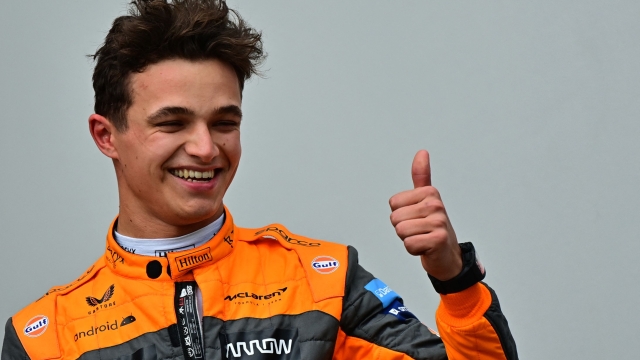 McLaren's British driver Lando Norris celebrates winning third place as he stands on the podium after the Emilia Romagna Formula One Grand Prix at the Autodromo Internazionale Enzo e Dino Ferrari race track in Imola, Italy, on April 24, 2022. (Photo by ANDREJ ISAKOVIC / AFP)