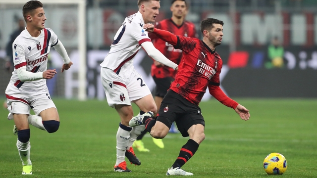 MILAN, ITALY - JANUARY 27: Christian Pulisic of AC Milan and Michel Aebischer of Bologna FC battle for the ball during the Serie A TIM match between AC Milan and Bologna FC - Serie A TIM  at Stadio Giuseppe Meazza on January 27, 2024 in Milan, Italy. (Photo by Marco Luzzani/Getty Images)
