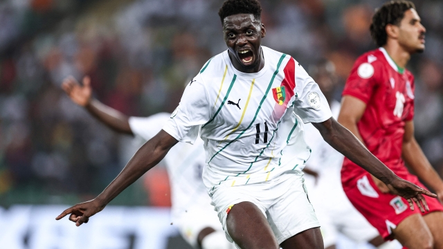 Guinea's midfielder #11 Mohamed Bayo celebrates scoring his team's first goal during the Africa Cup of Nations (CAN) 2024 round of 16 football match between Equatorial Guinea and Guinea at the Alassane Ouattara Stadium in Ebimpe, Abidjan, on January 28, 2024. (Photo by FRANCK FIFE / AFP)