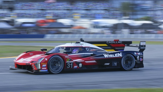Tom Blomqvist, of Britain, drives the Cadillac V-Series R through a turn during a practice session for the Rolex 24 hour auto race at Daytona International Speedway, Thursday, Jan. 25, 2024, in Daytona Beach, Fla. (AP Photo/John Raoux)