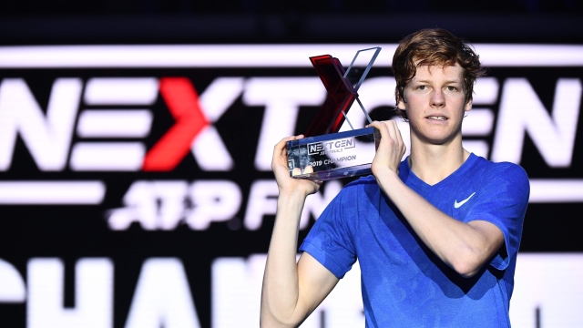 Italy's Jannik Sinner poses with the winner's trophy after defeating Australia's Alex De Minaur during the final of the Next Generation ATP Finals at the Allianz Cloud Court on November 9, 2019 in Milan. (Photo by Marco Bertorello / AFP)