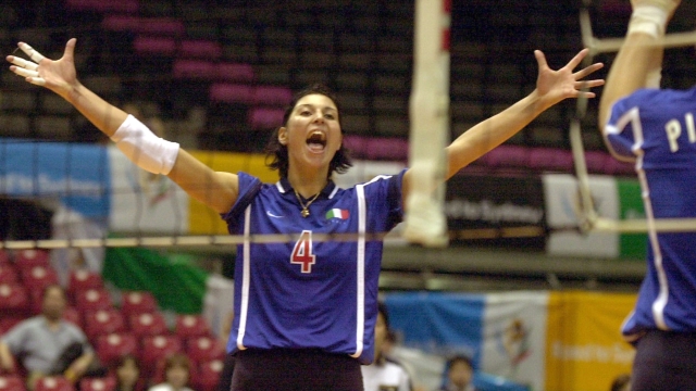 Italy's Manuela Leggeri spreads her arms to celebrate her team's point during a match against the Netherlands in the women's world volleyball final qualification for the Sydney Olympic Games in Tokyo Saturday, June 17, 2000. Italy won the match 22-25, 19-25, 25-19, 25-23, 15-4. (AP Photo/Katsumi Kasahara)