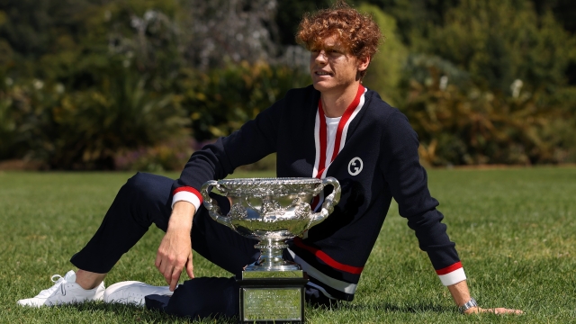 MELBOURNE, AUSTRALIA - JANUARY 29: Jannik Sinner of Italy poses with the Norman Brookes Challenge Cup after winning the 2024 Australian Open Final, at Royal Botanic Gardens on January 29, 2024 in Melbourne, Australia. (Photo by Kelly Defina/Getty Images)