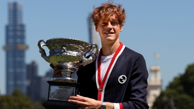 MELBOURNE, AUSTRALIA - JANUARY 29: Jannik Sinner of Italy poses with the Norman Brookes Challenge Cup after winning the 2024 Australian Open Final, at Royal Botanic Gardens on January 29, 2024 in Melbourne, Australia. (Photo by Kelly Defina/Getty Images)