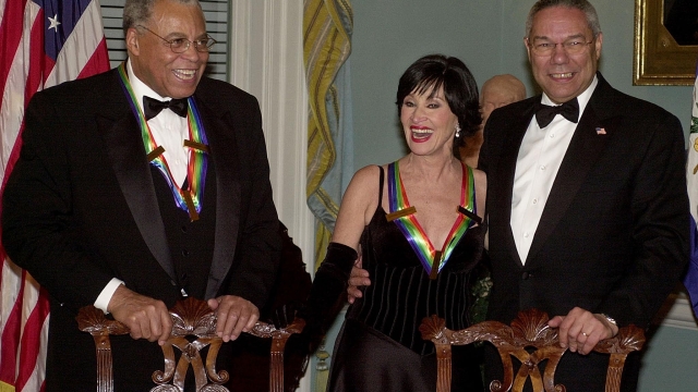 (FILES) US Secretary of State Colin Powell (R), stands with Kennedy Center honorees actor James Earl Jones (L) and actress Chita Rivera (C) before sitting for a class portrait 7 December 2002 after the Kennedy Center Honors Gala at the US State Department in Washington, DC. Chita Rivera -- a singer, dancer and actress who lit up Broadway stages over six decades in such shows as "West Side Story" and "Chicago" as one of the foremost entertainers of her generation -- died at the age of 91 on January 30, 2024, her publicist said. (Photo by SHAWN THEW / AFP)