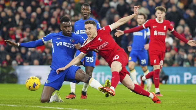 Liverpool's Diogo Jota scores his side's first goal during the English Premier League soccer match between Liverpool and Chelsea, at Anfield Stadium, Liverpool, England, Wednesday, Jan.31, 2024. (AP Photo/Jon Super)